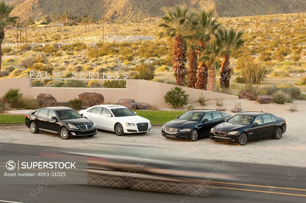 Comparison of four 2012 long wheelbase sedans, including the Audi A8 L, BMW 750Li, Hyundai Equus and Jaguar XJL parked in the desert