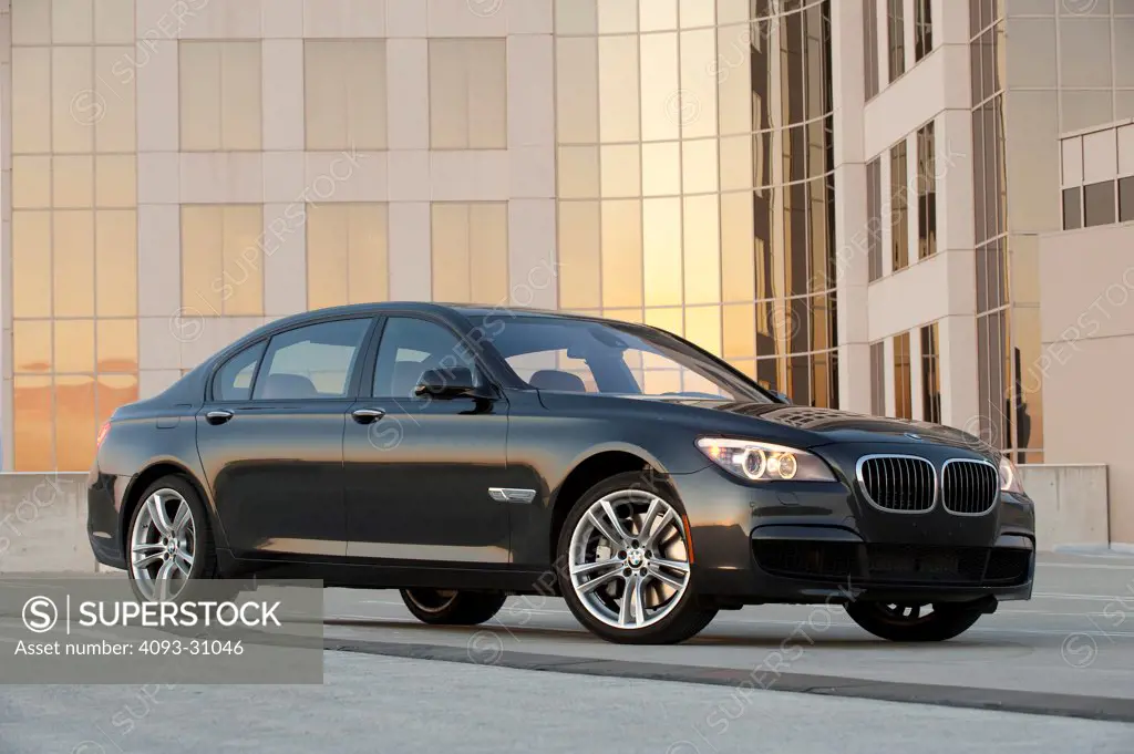 Front 7/8 view of a black 2011 BMW 760Li parked in a city at sunset.