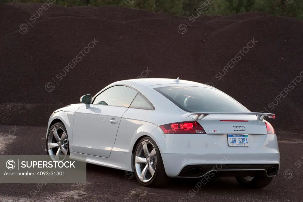 Rear 3/4 view of a white 2012 Audi TT RS parked at a rural turnout.