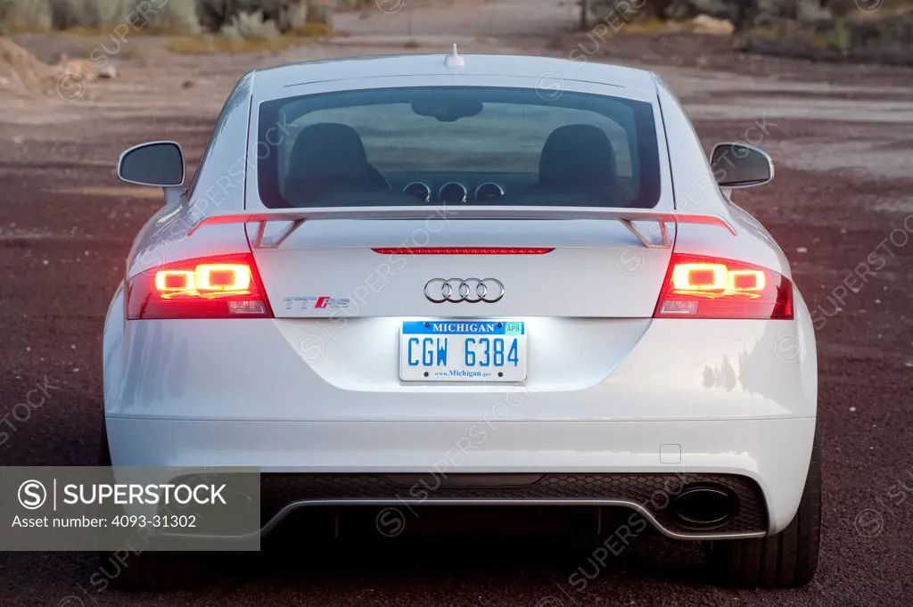 Rear view of a white 2012 Audi TT RS parked at a rural turnout.