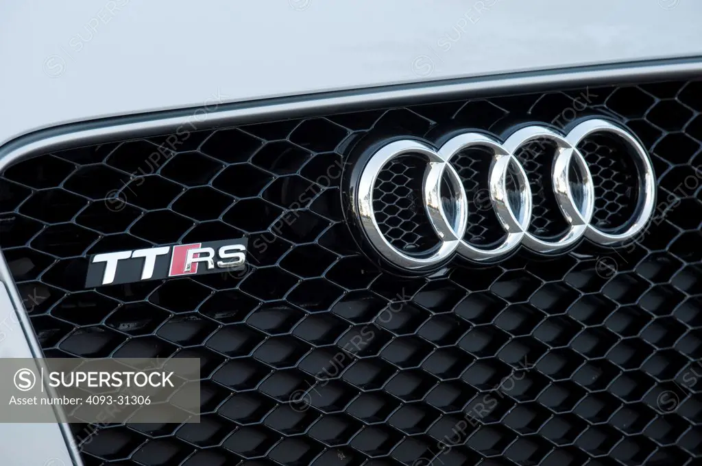 Front nose detail of a white 2012 Audi TT RS, showing the grille and badge.