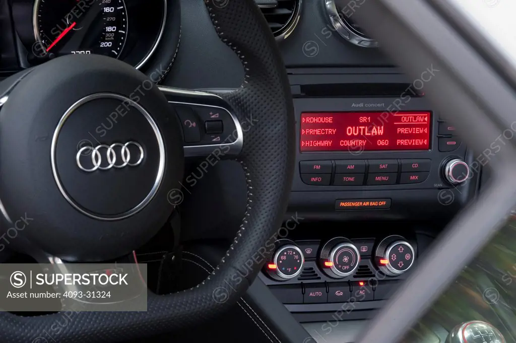 Detail view of the steering wheel and center console of a 2012 Audi TT RS.