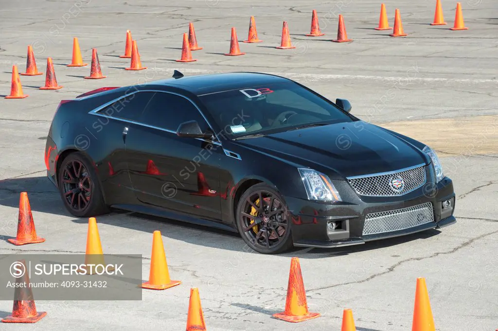 Front 7/8 view of a 2012 Cadillac CTS-V driving on a test track.