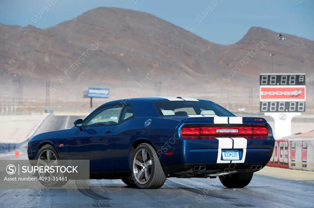 Rear 3/4 of a 2012 Dodge Challenger SRT8 392 Hemi parked on a racing track.