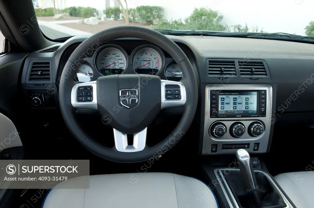 Detail of the interior of a 2012 Dodge Challenger SRT8 392 Hemi showing the dash, steering wheel and seats.