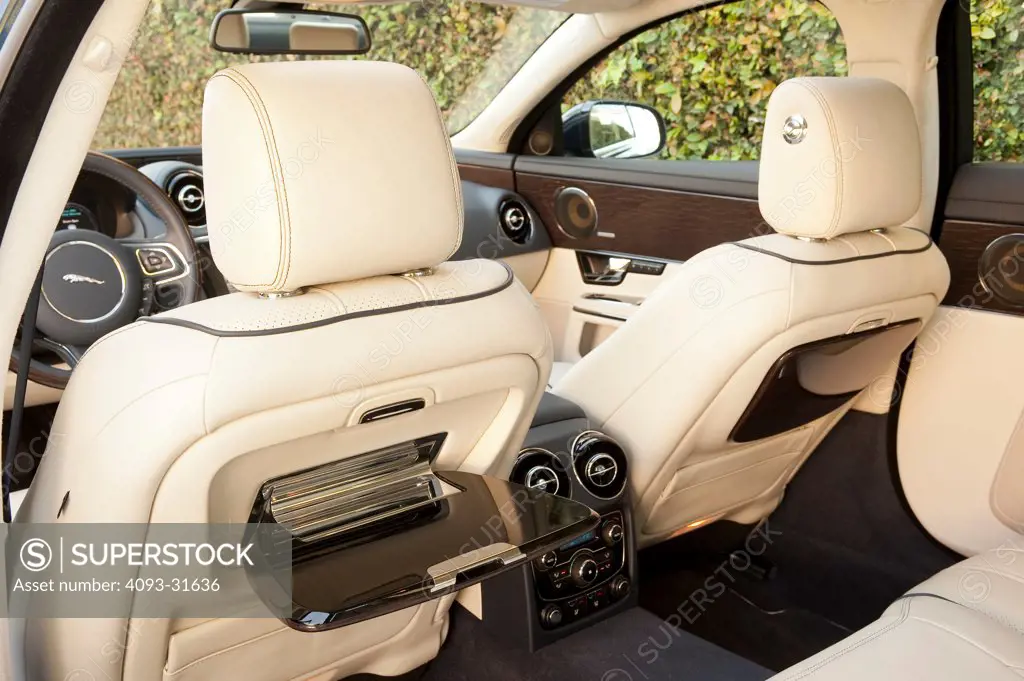 Detail of the 2012 Jaguar XJL showing the rear passenger seat tray tables.