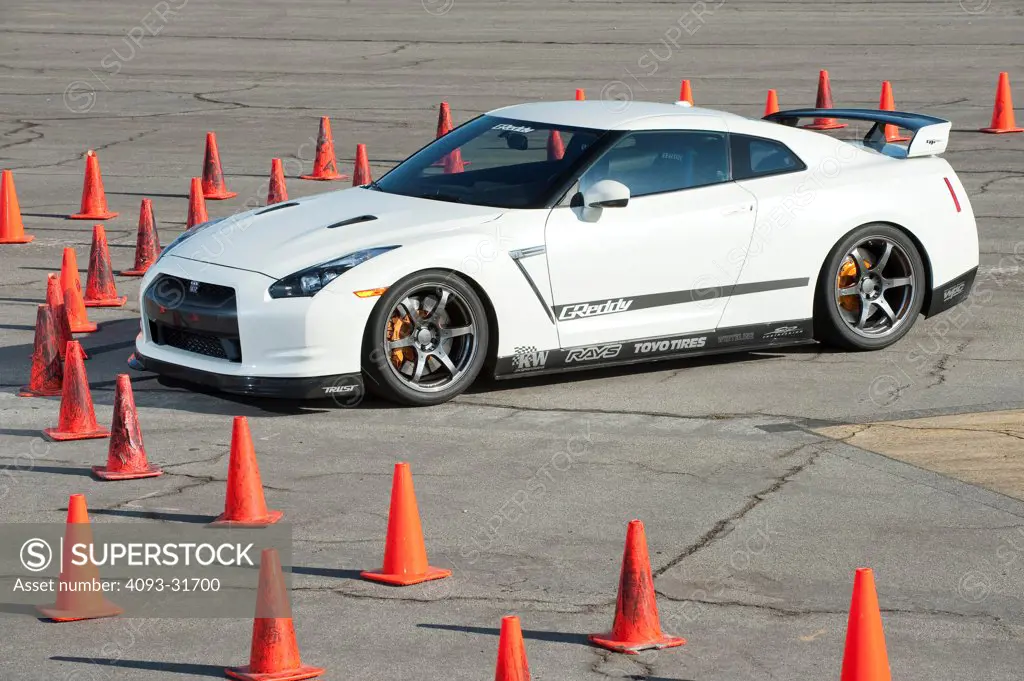 Front 7/8 view of a 2012 Nissan GT-R parked on a test track.