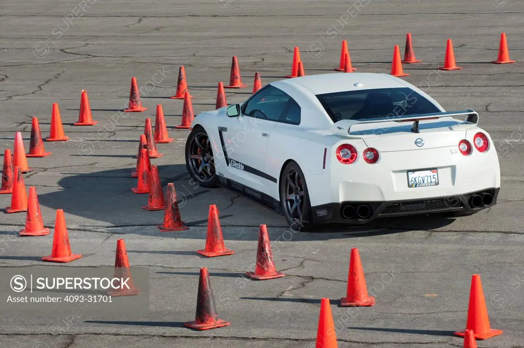 Rear 3/4 view of a 2012 Nissan GT-R parked on a test track.