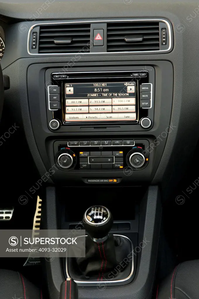 Detail view of the center console of a 2012 Volkswagen Jetta GLI showing the stereo, shifter and air vents.