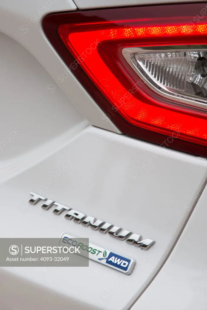 Detail of the rear tail light and badge of a 2013 Ford Fusion Titanium.