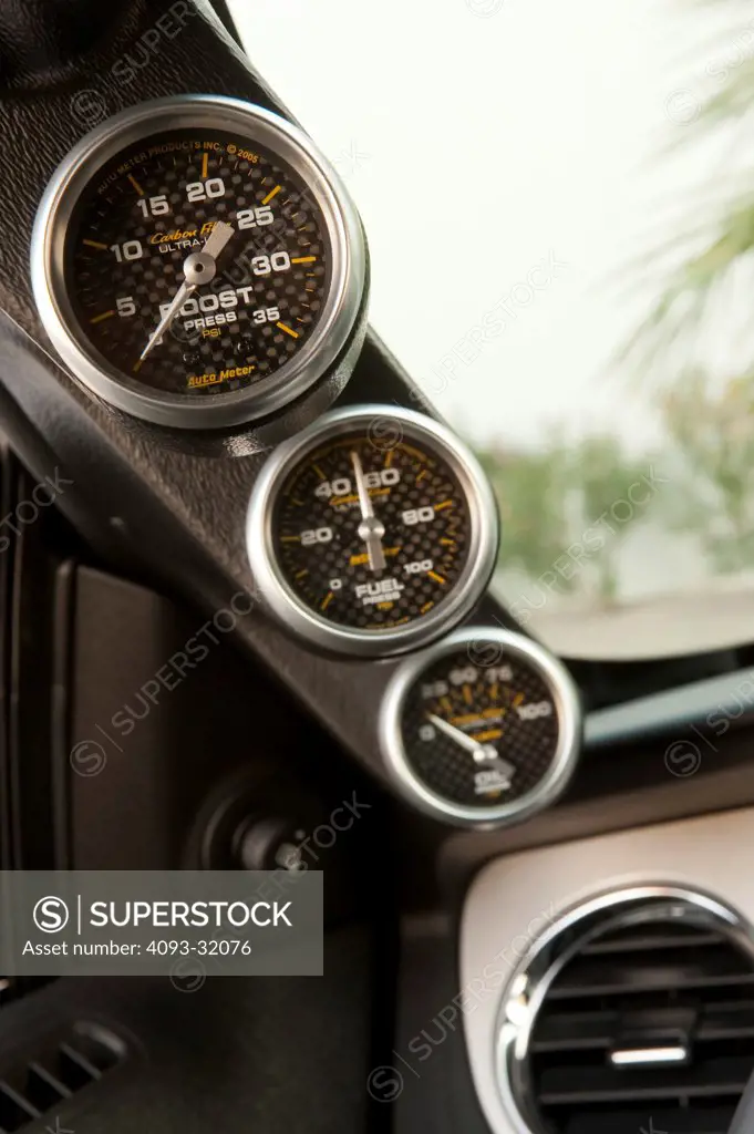 Detail of the gauges along the A pillar of a 2011 Ford Mustang Shelby GT350 45th Anniversary Edition