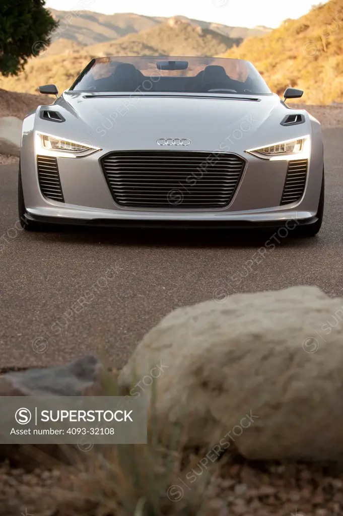 Wide angle front view of a convertible silver Audi e-tron Spyder Concept parked in the desert.