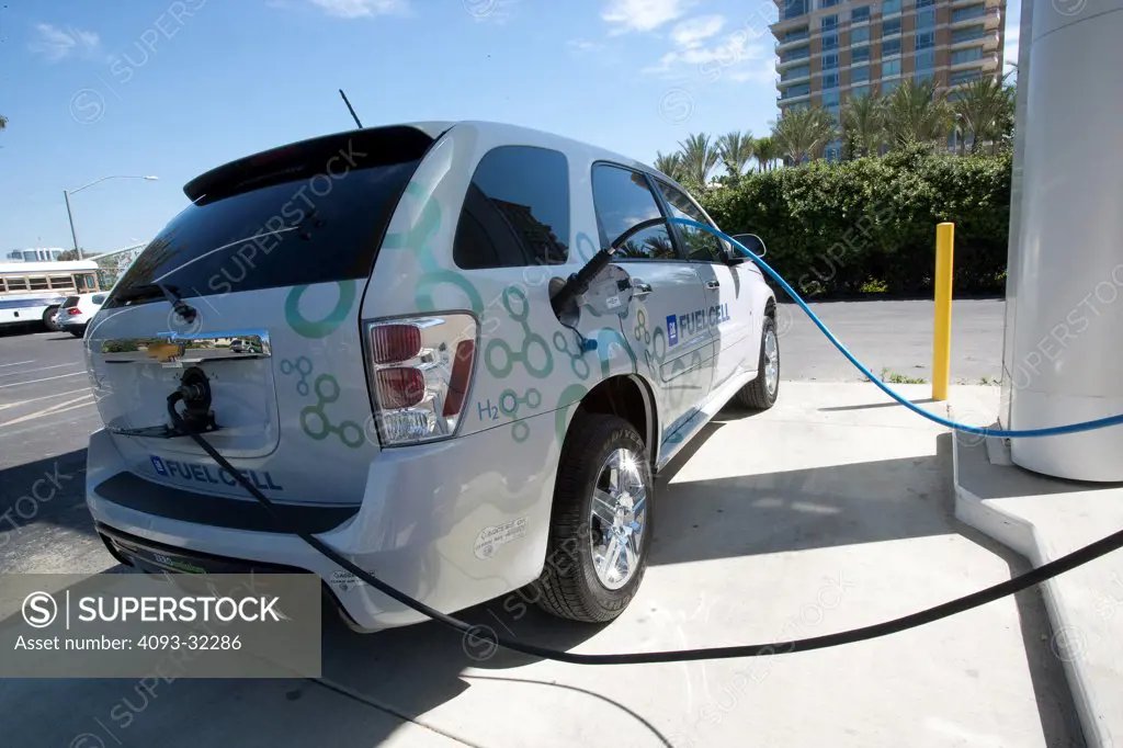 2010 Chevrolet Equinox Hydrogen Fuel Cell SUV being refuelled at station, rear 7/8