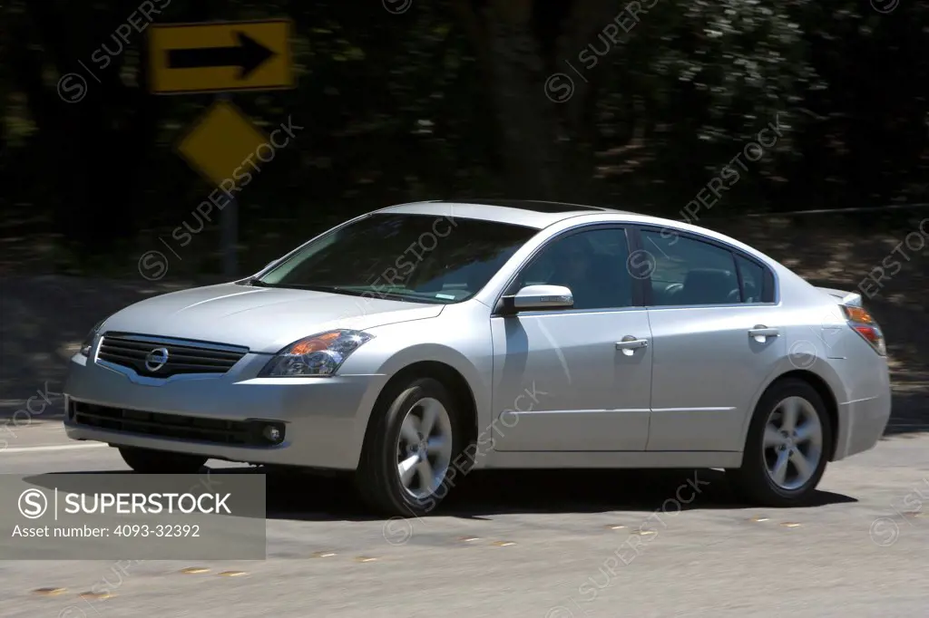 2007 Nissan Altima Hybrid Sedan front 3/4 action view on suburban road