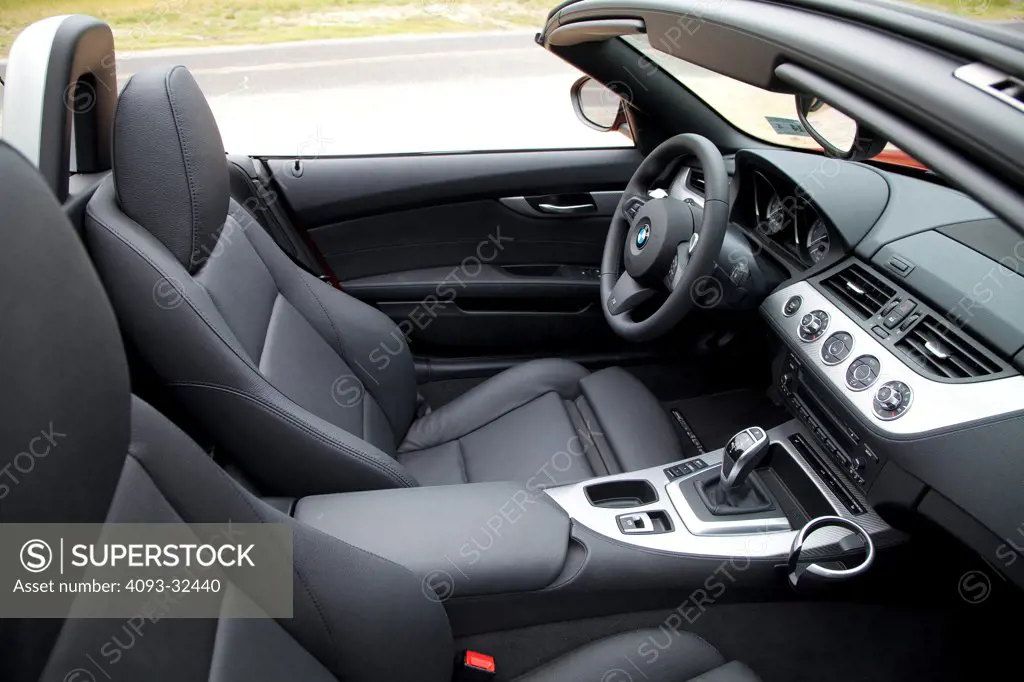 2011 BMW Z4 with the top down, driver's seat, steering wheel, instrument panel, center console and dashboard.