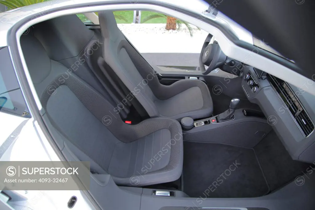 Interior of the 2011 Volkswagen XL1 concept. The diesel plug-in hybrid prototype is branded as a Super Efficient Vehicle (SEV). Showing the cloth seats.