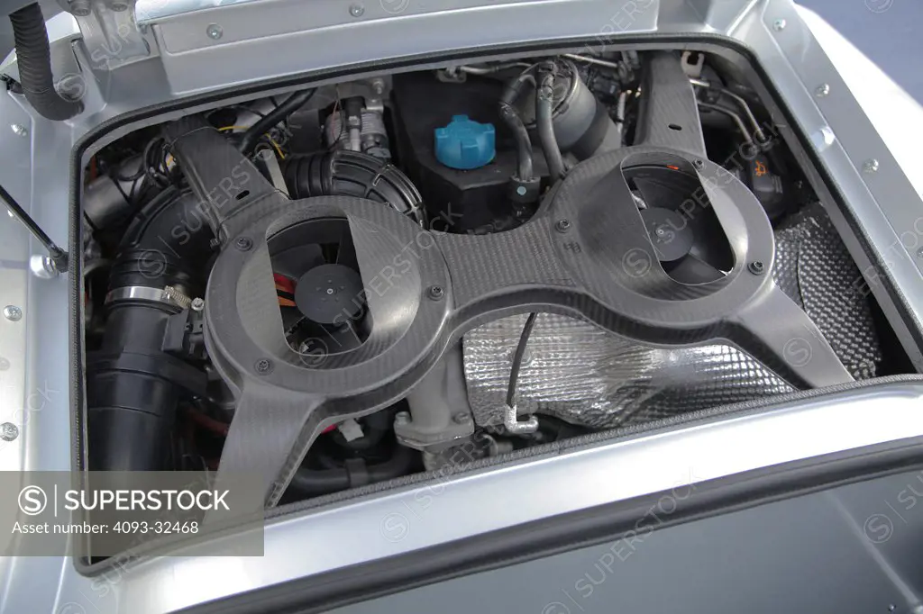 Engine view of the silver 2011 Volkswagen XL1 concept. The diesel plug-in hybrid prototype is branded as a Super Efficient Vehicle (SEV). Showing the unusual motor and cooling system.