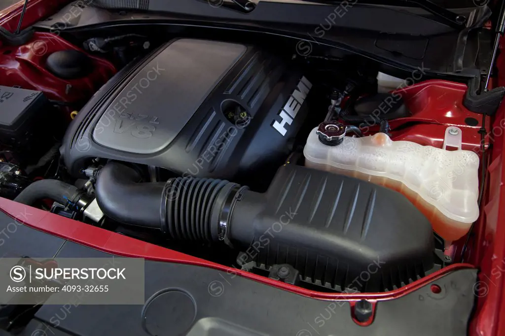 Engine view of a red 2012 Dodge Charger R/T showing the 5.7 liter V8 HEMI motor.