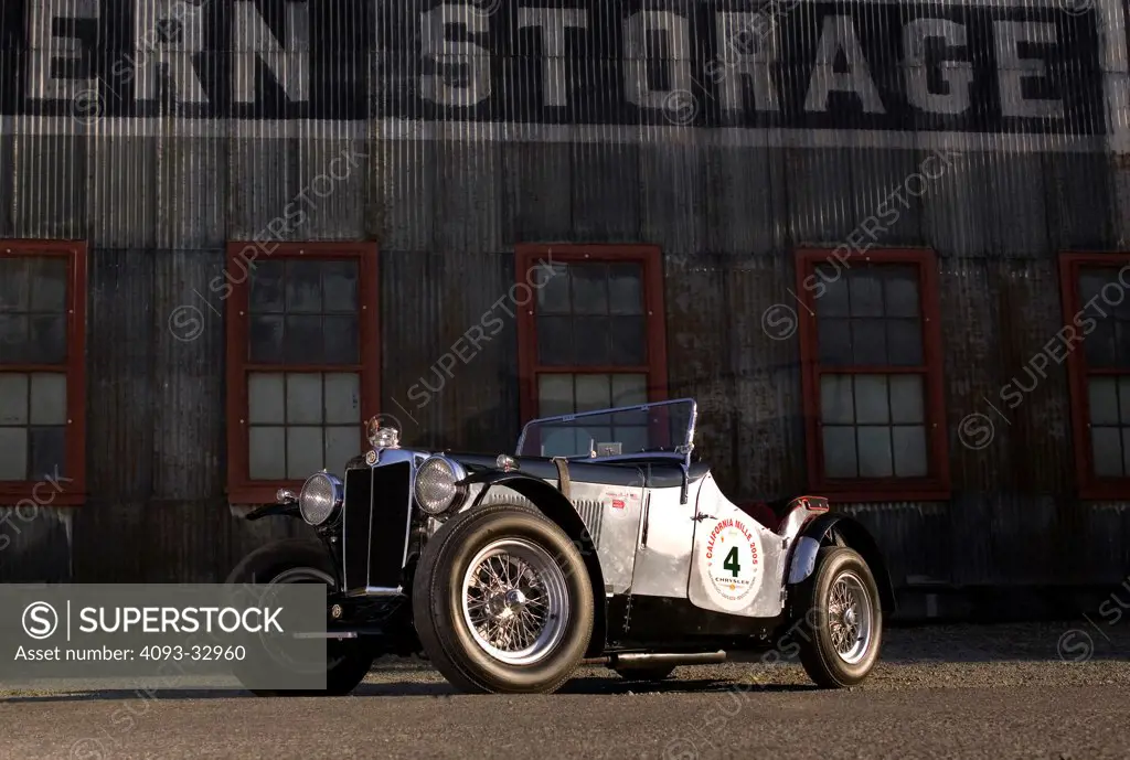 1930's MG NA parked by storage building, front 3/4