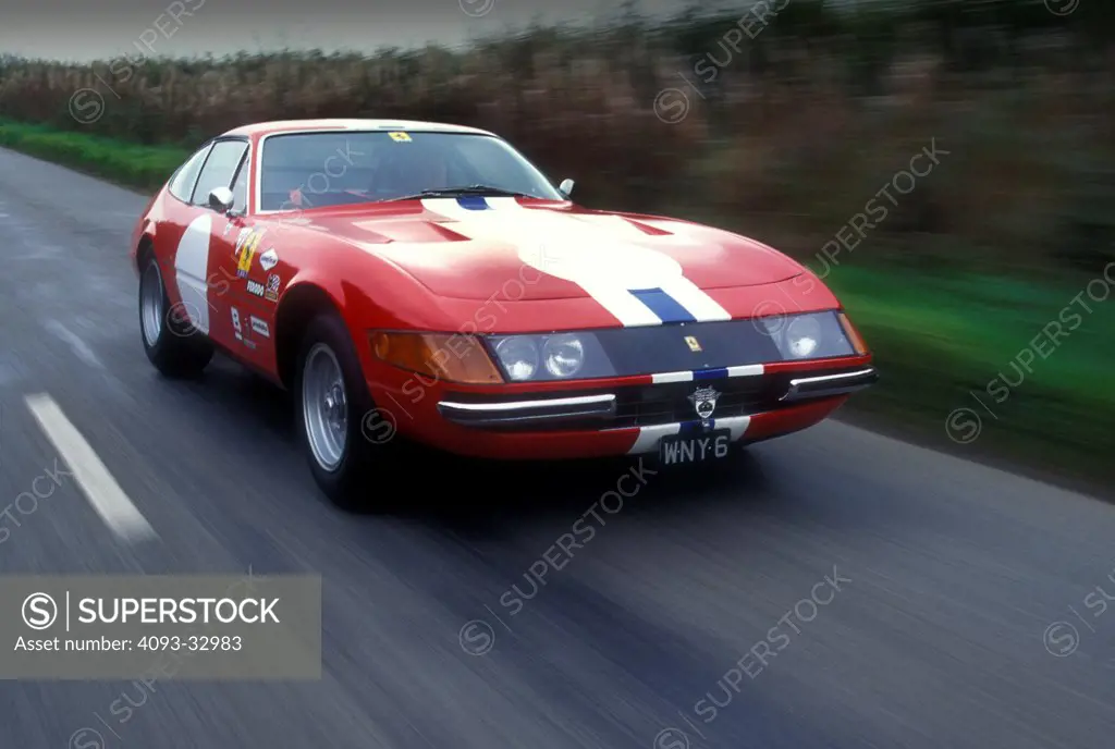 1972 Ferrari 365 GTC/4A Comp driving along country road, front 3/4