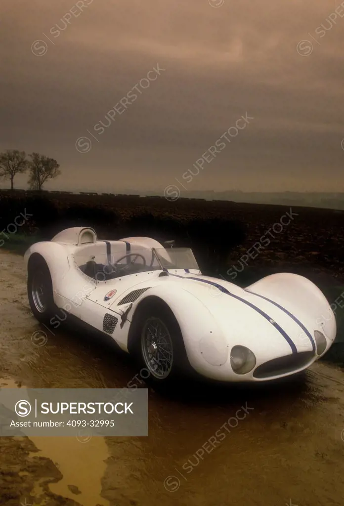 1961 Maserati Tipo 61 Birdcage parked on muddy track, front 3/4
