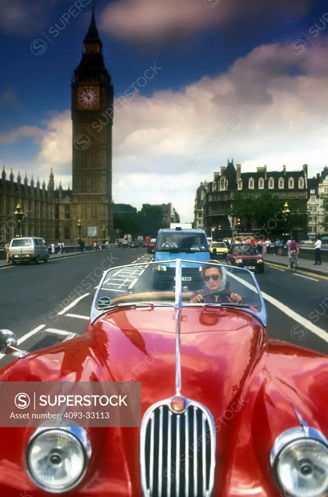1950 Jaguar XK120 driving through city, front view