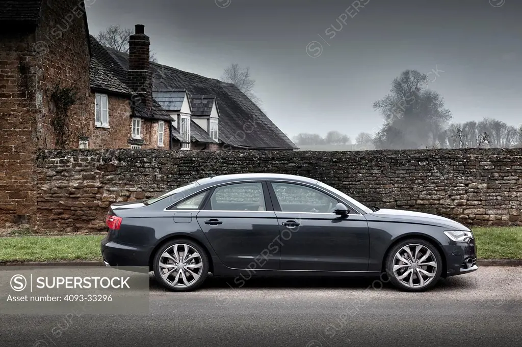 2011 Audi A6 Quattro parked on rural road, side view