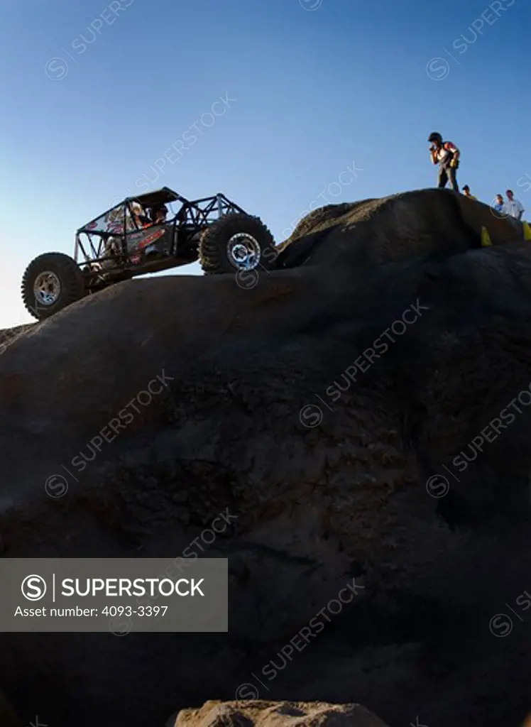 Rock Crawling vehicles climbing while people watch