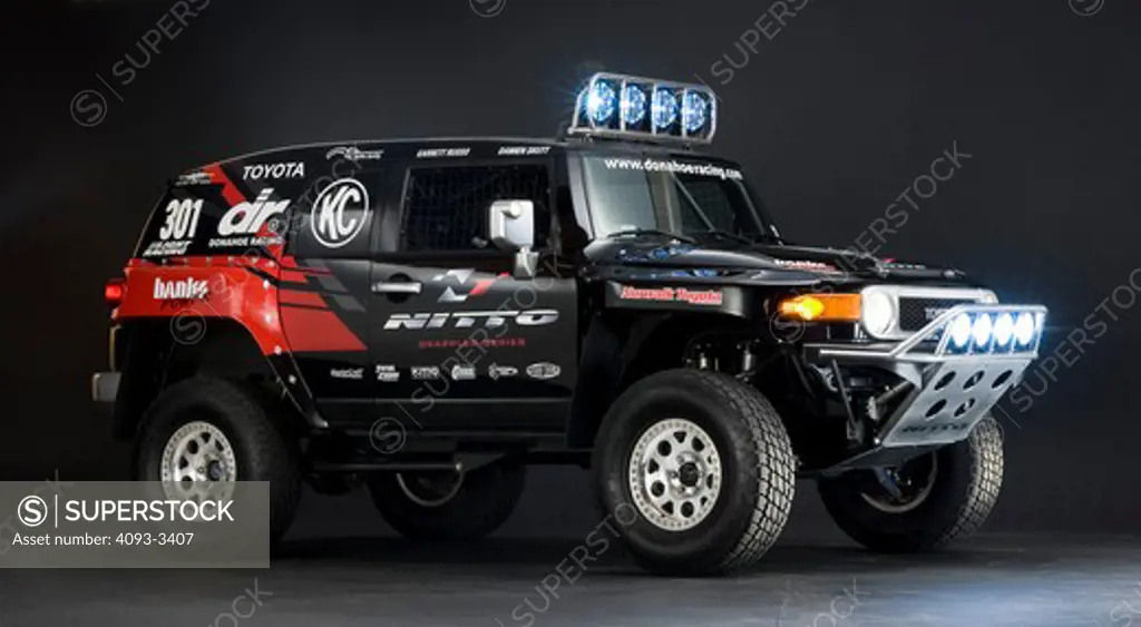 Toyota baja desert race truck in the studio with lights on and sponsor stickers