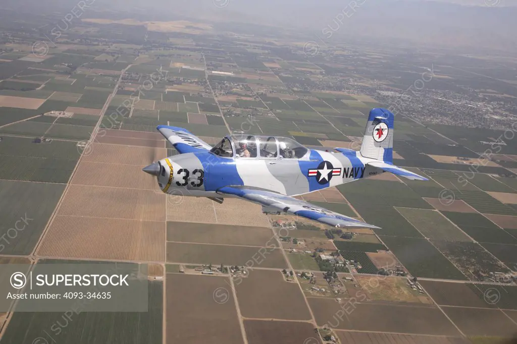 US Navy 1953 Beechcraft T-34 Mentor trainer flying over the Central Valley of California.