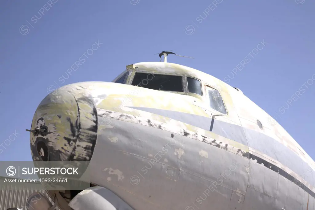 Detail view of an abandoned 1938 Douglas DC-4 airliner in a rural, desert junkyard.