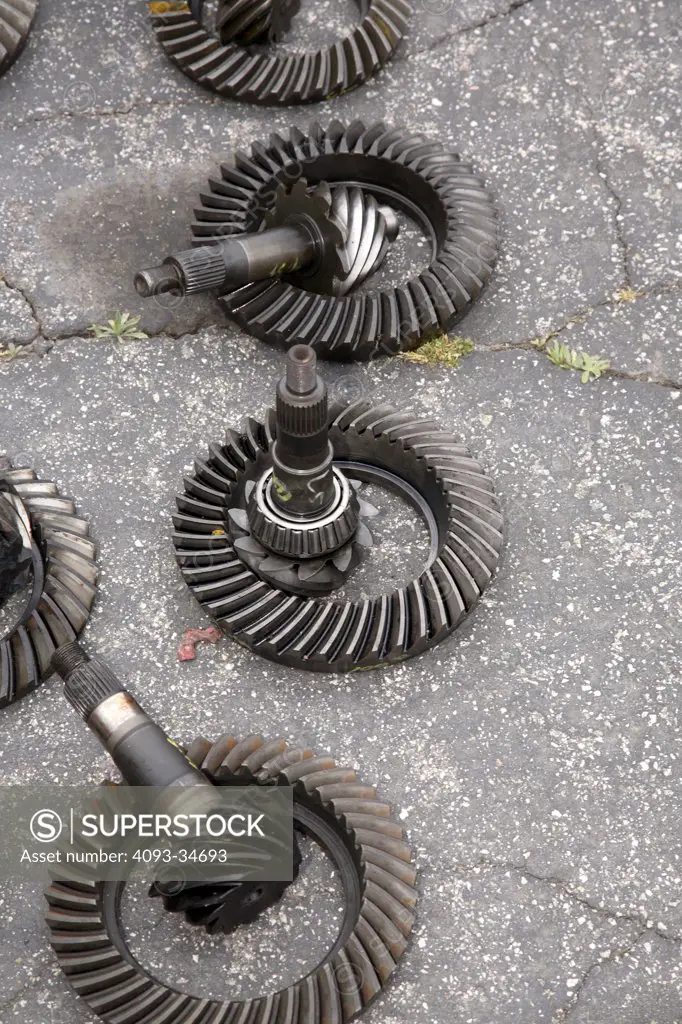 Used rotary gears for sale at a junk yard.