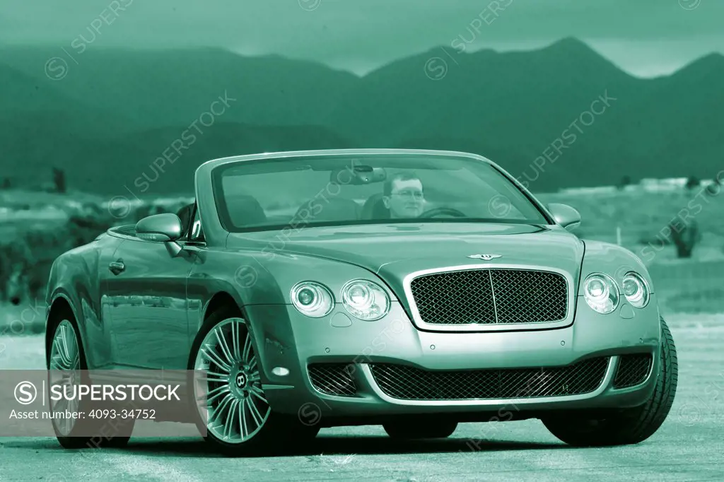 Front 3/4 static view of a 2010,bentley Continental GTC. Green tone.