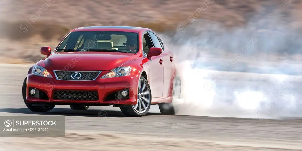 Front 3/4 action view of a red 2010 Lexus IS-F in a four wheel drift.