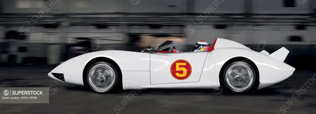 Profile action view of Speed Racer's Mach 5 race car inside a secret location warehouse.
