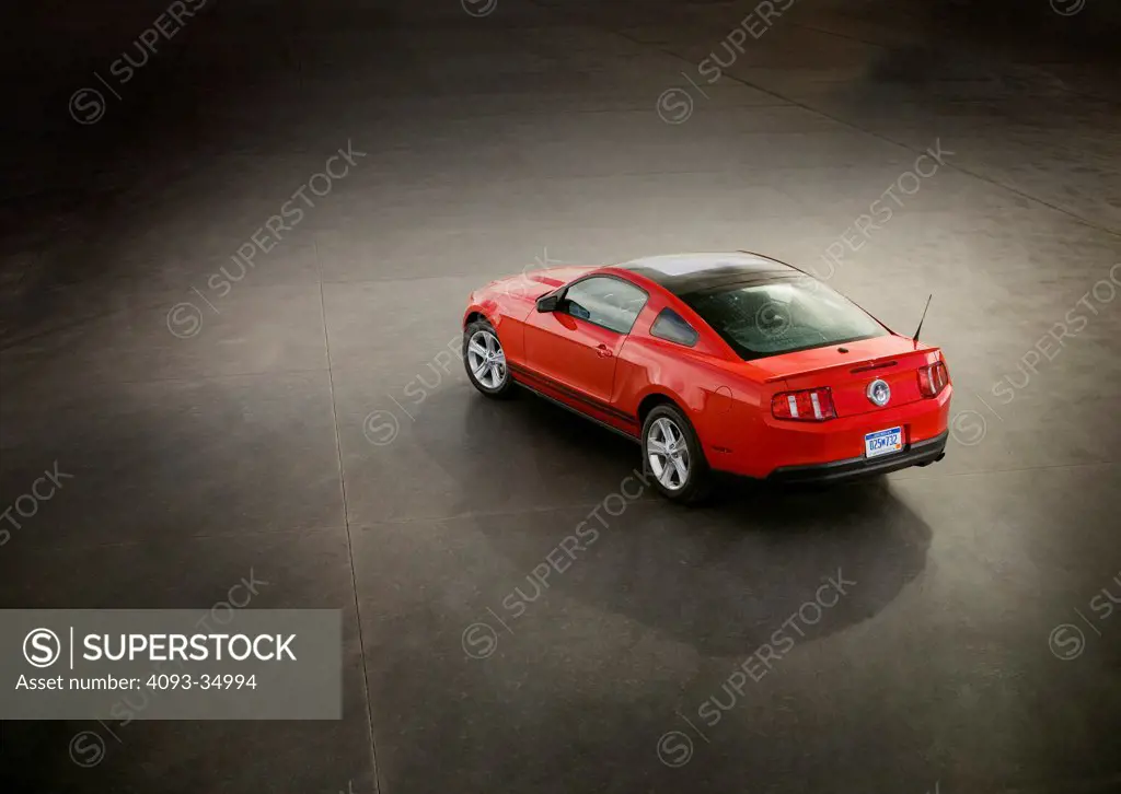 Overhead rear 3/4 static view of a red 2010 Ford Mustang GT on a concrete skid pad.