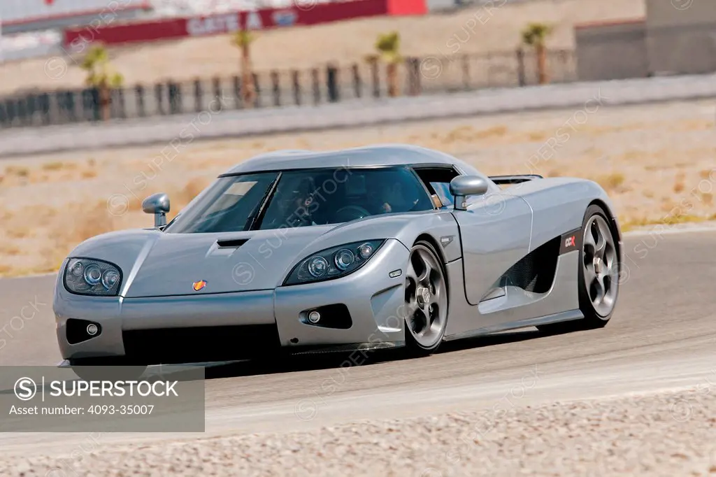 Front 3/4 action view of the wild Koenigsegg CCX on a race track. This is an 806-bhp carbon-fiber exotic from Sweden!