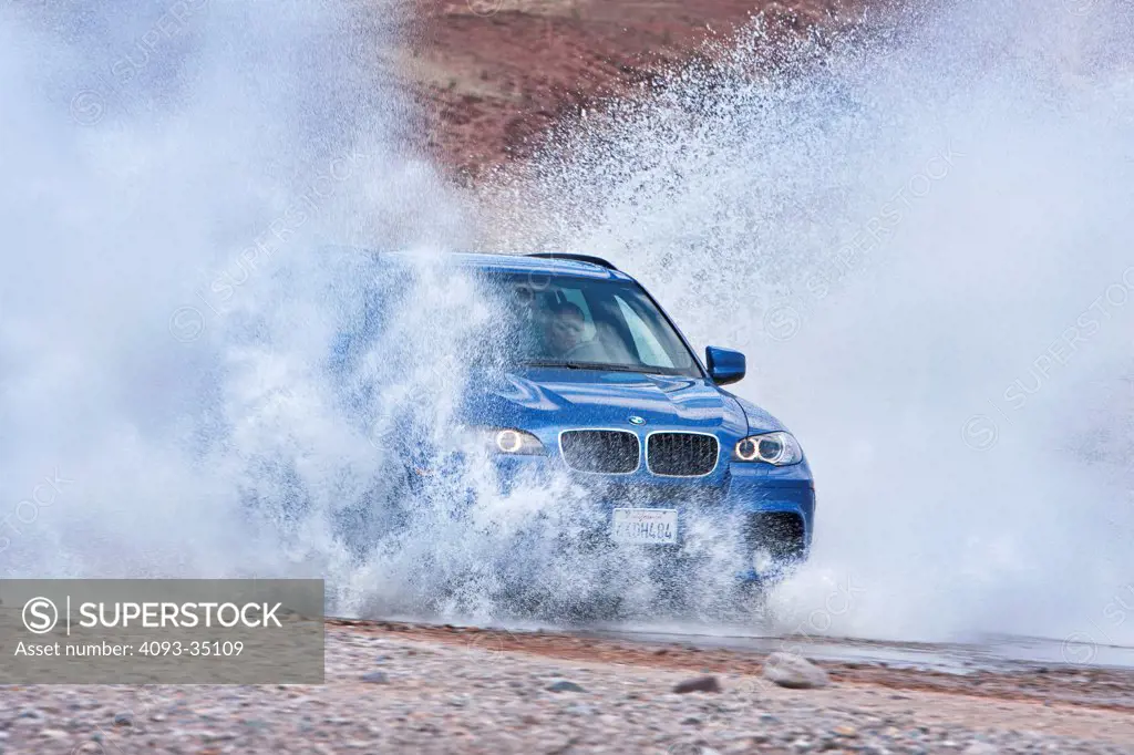 2010 BMW X5M in action through water, front 3/4