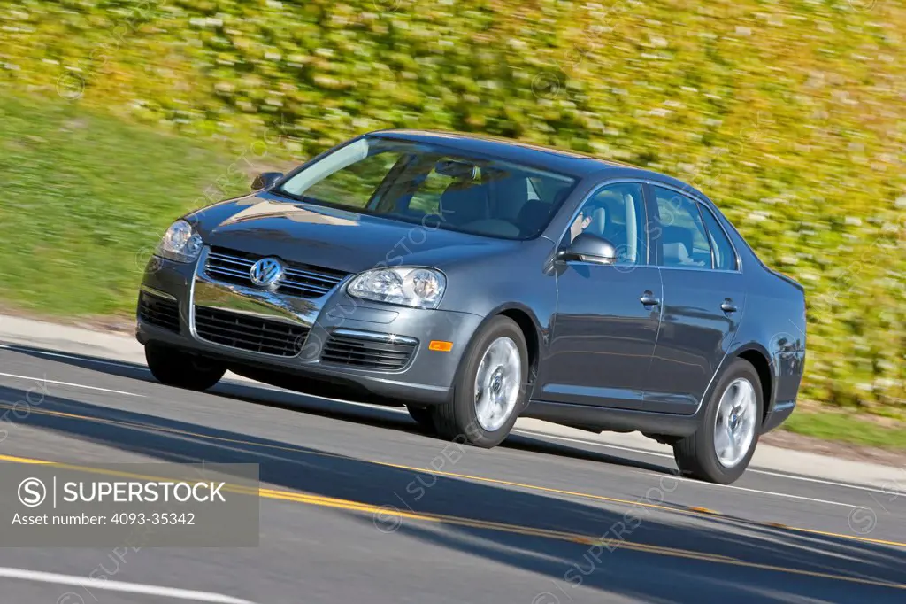2009 Volkswagen Jetta on suburban road, front 3/4