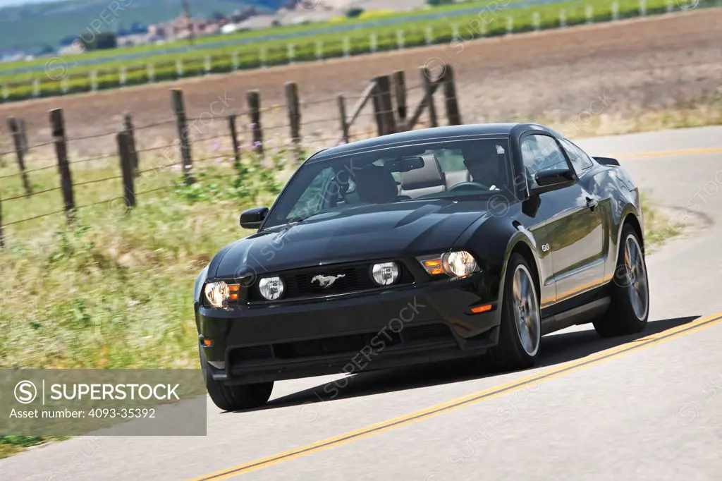 2011 Ford Mustang GT on road, front 3/4