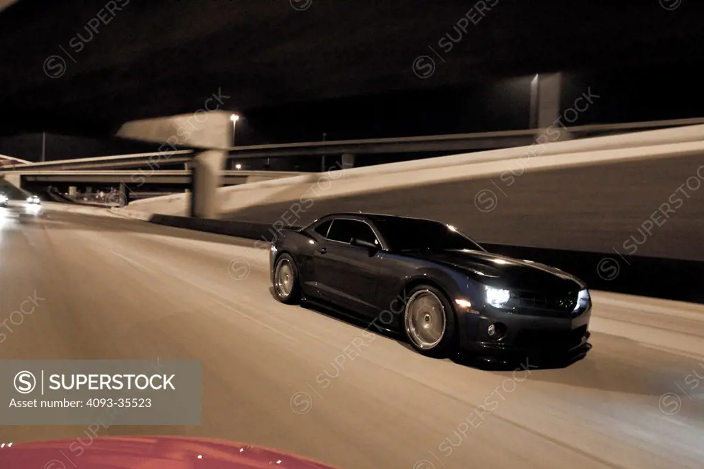 2010 Hennessey HPE700 Camaro on city roasd at night, front 7/8