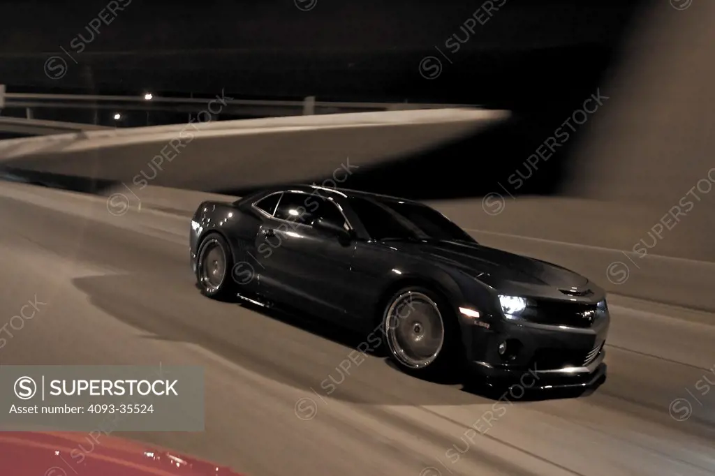 2010 Hennessey HPE700 Camaro on city roasd at night, front 7/8