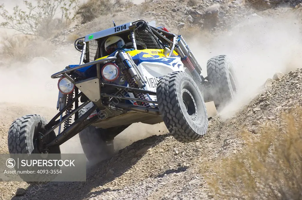 ATV baja desert racer in action during a sunny day on a dirt track