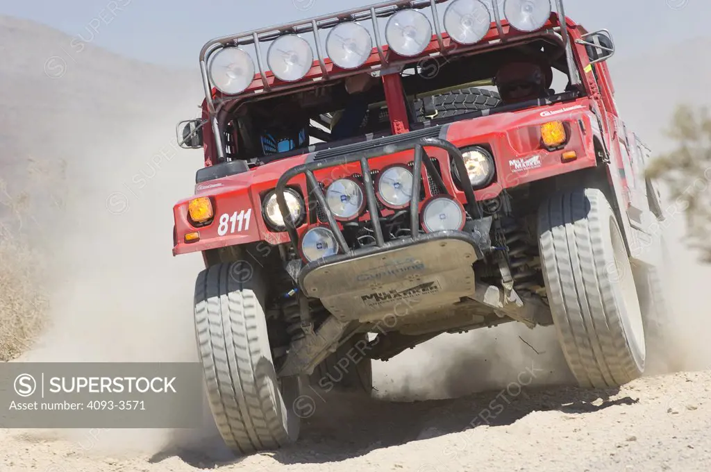 Hummer off road racing and kicking up dust