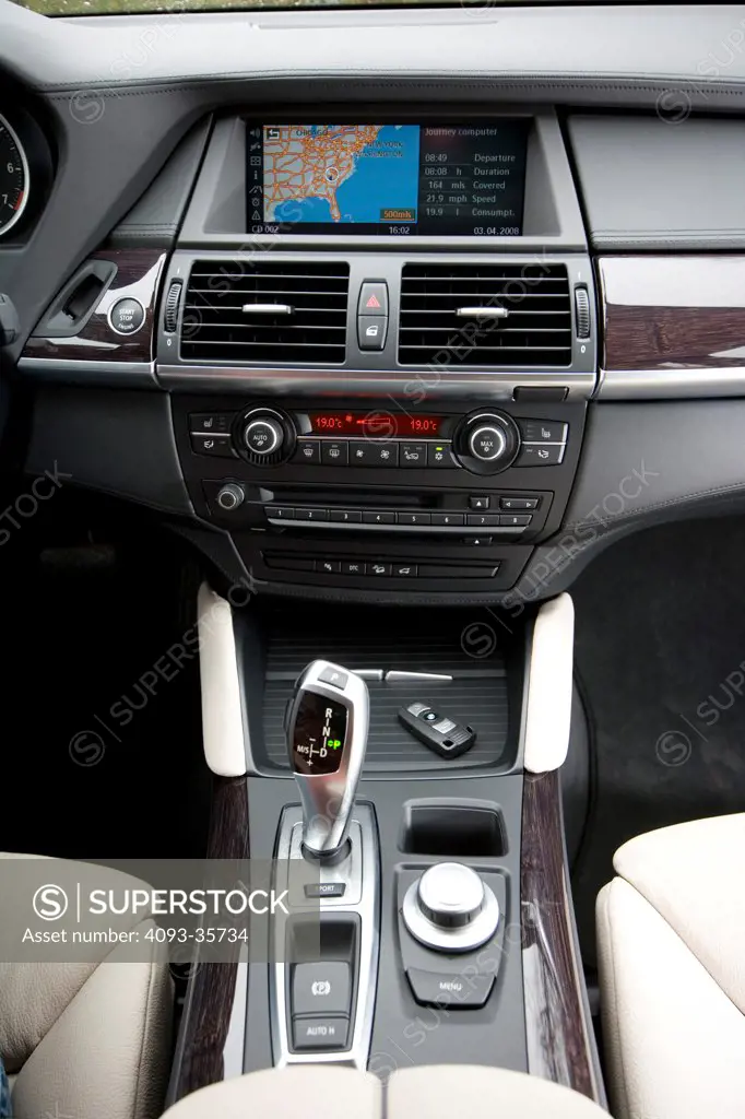2008 BMW X6 showing the center console, radio, gear shift lever, iDrive adjustment knob and parking brake