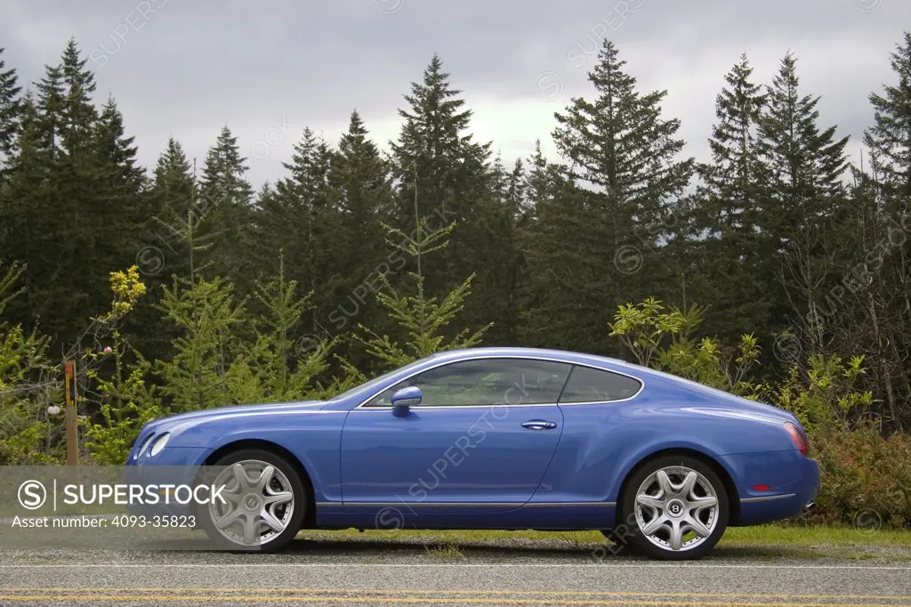 2007,bentley Continental GT parked on a rural gravel, tree lined road, side view