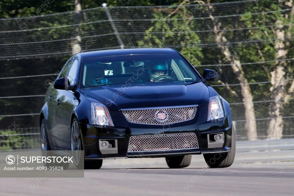 2009 Cadillac CTS-V hard cornering on a rural race track, front 3/4