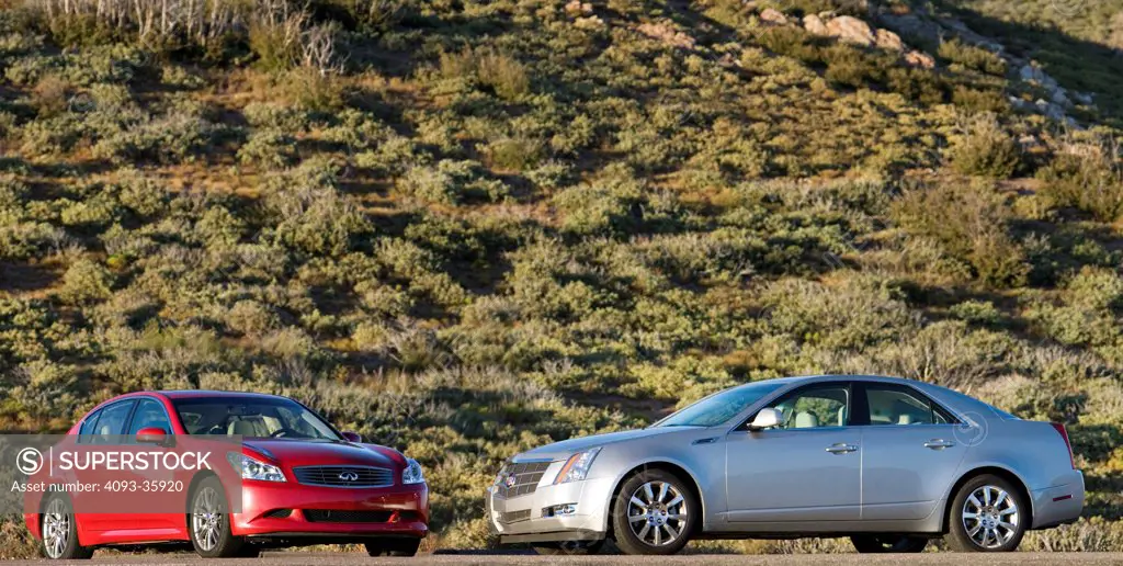 2008 Cadillac CTS and 2007 Infiniti G35 Sport parked by hill, front 7/8 and 3/4