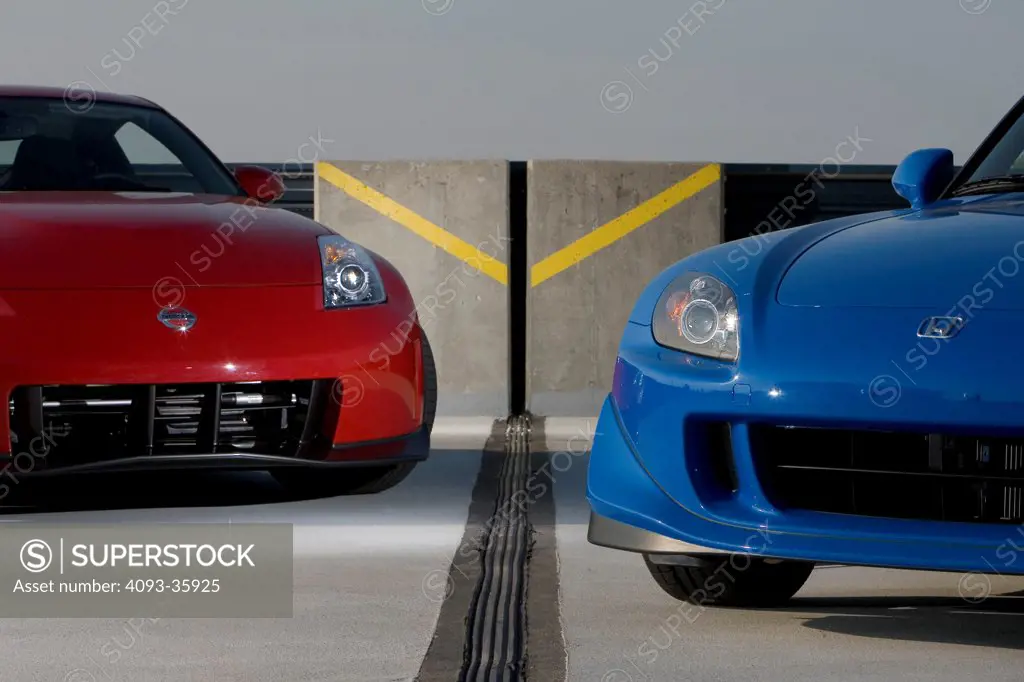 2008 Honda S2000 and red 2007 Nissan Nismo 350Z parked in a parking structure