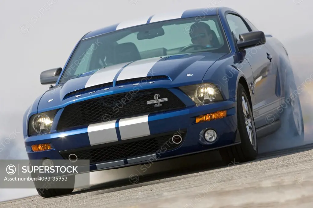 2008 Ford Mustang Shelby GT500KR doing a burnout, front 3/4